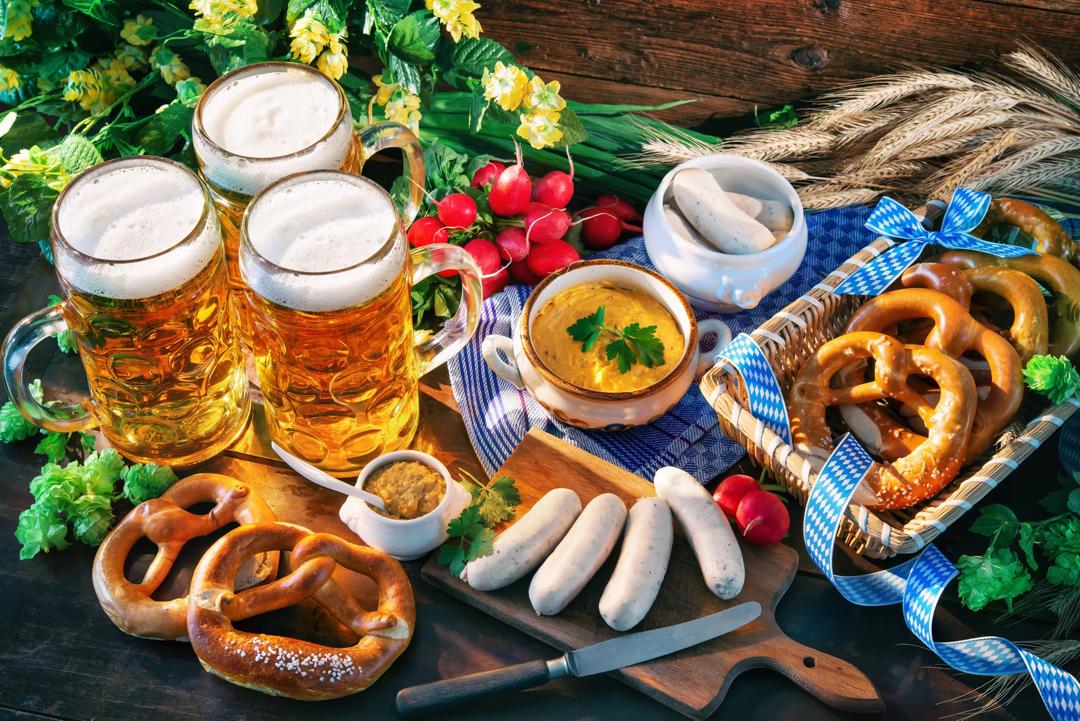An assortment of delicious pretzels, sausages, dips and beer abourd a Main River Cruise
