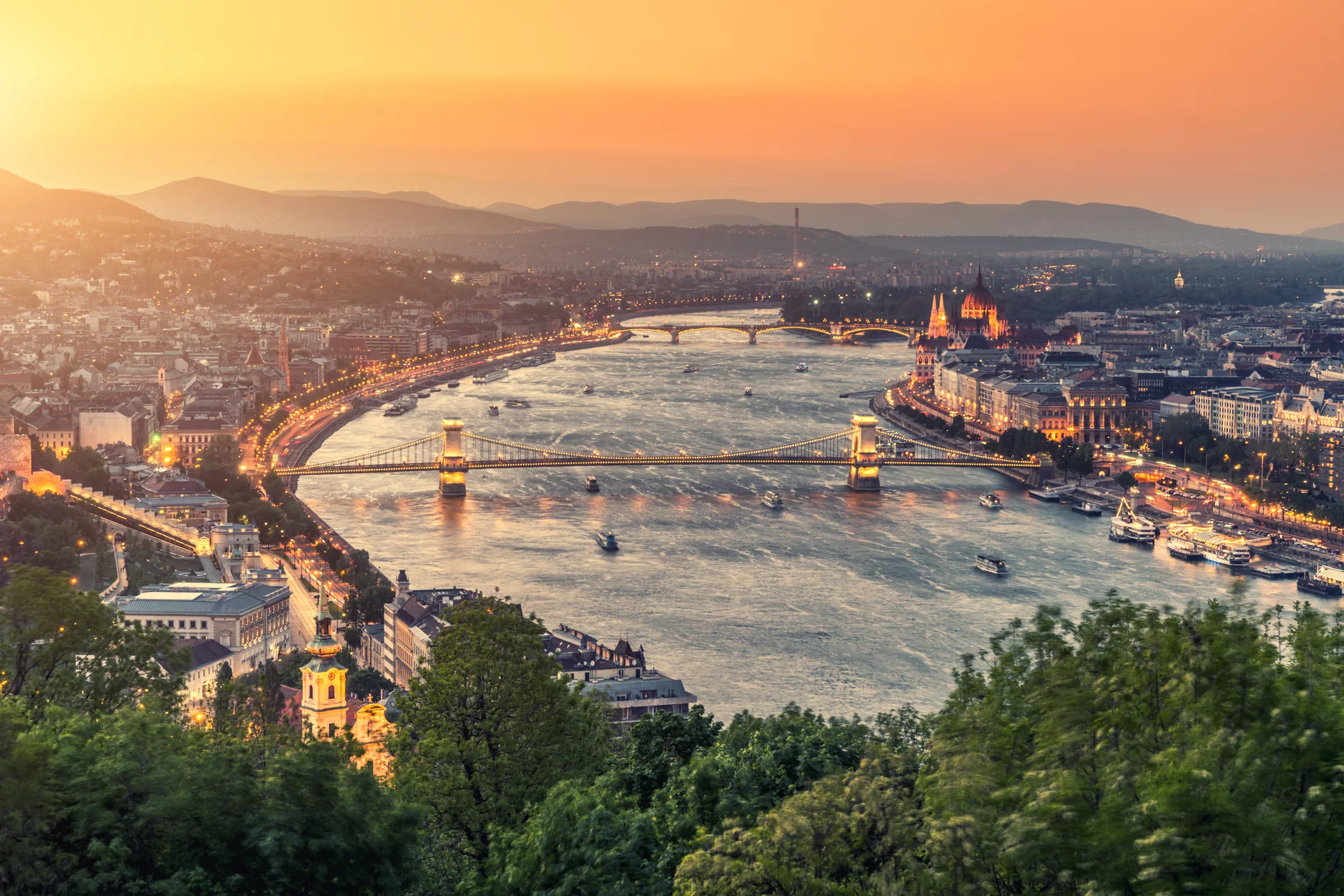 An aerial view of Budapest and the Danube River at sunset