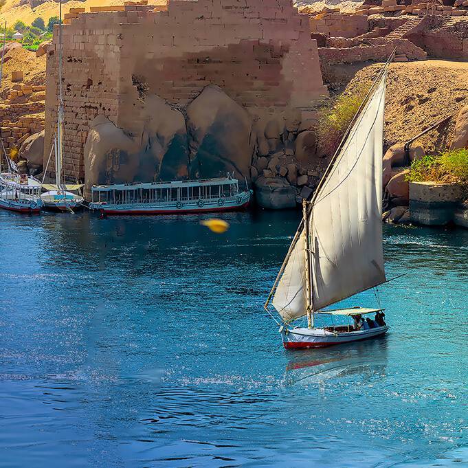 A small boat cruising across the scenic River Nile.